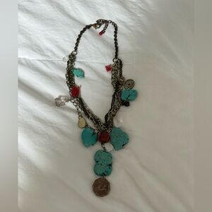 Stone necklace with charms.
